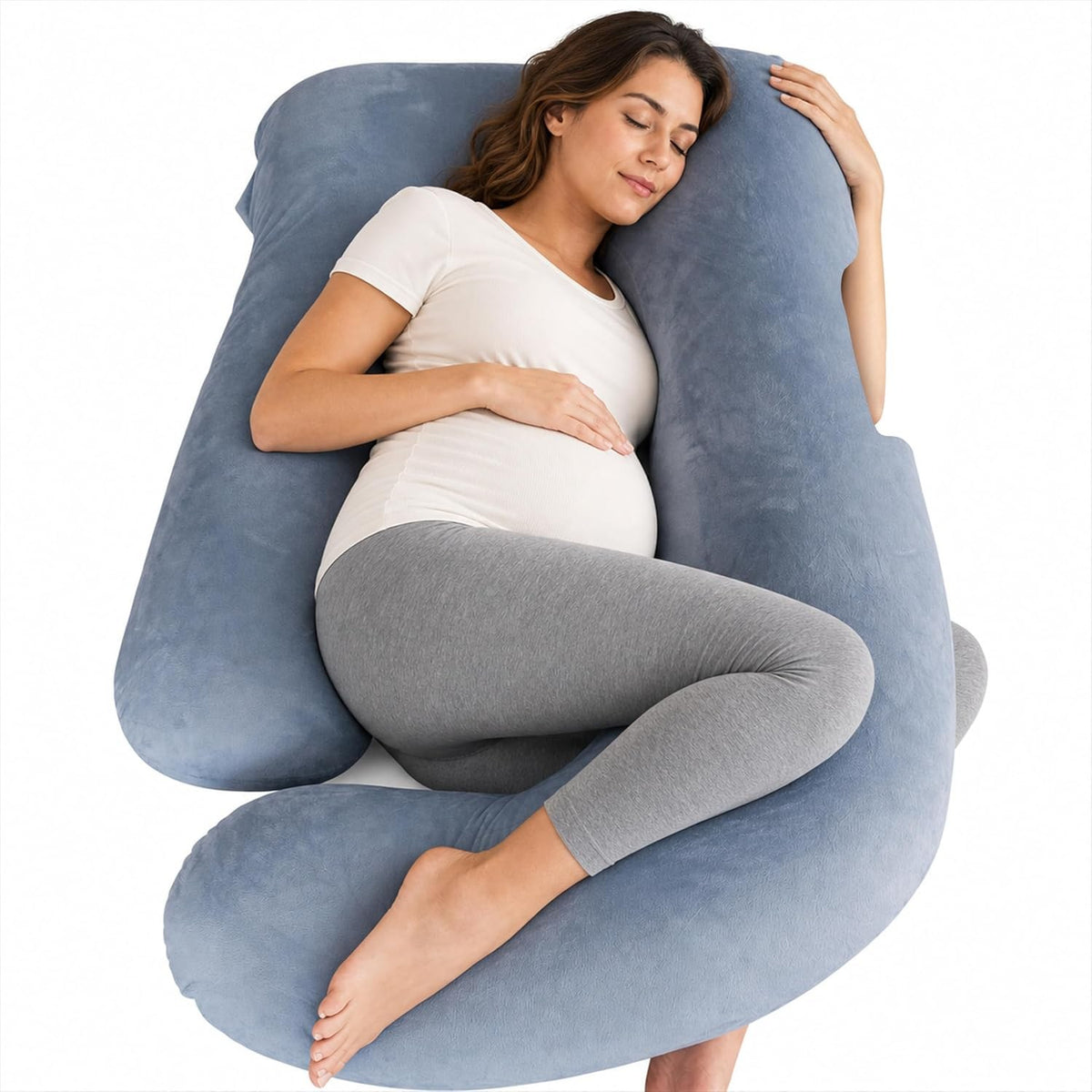 Pregnant woman asleep on her side inside a blue grey U shaped full body pregnancy pillow